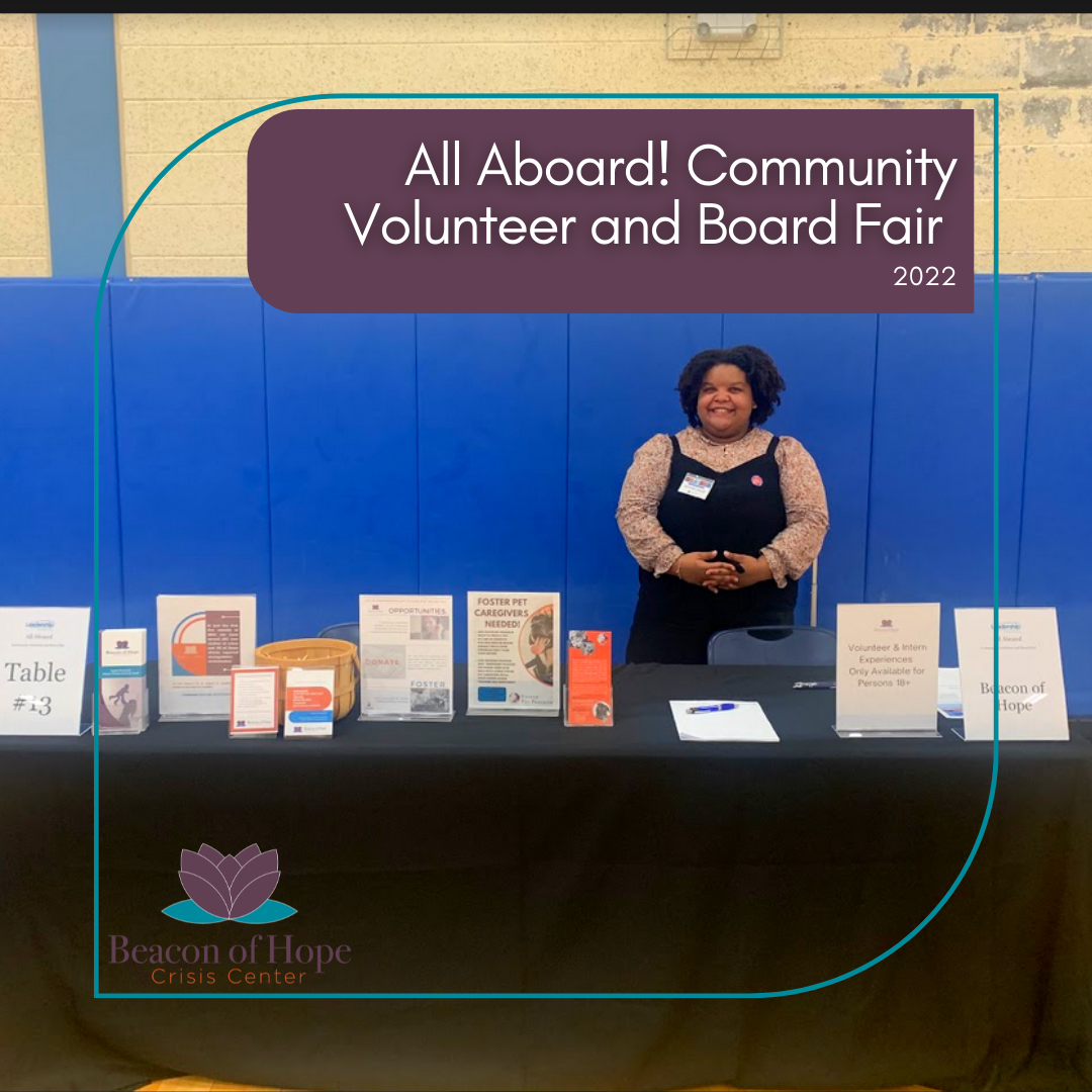 Beacon of Hope Crisis Center representative at a table with promotional materials with overlay stating: All Aboard! Community Volunteer and Board Fair 2022