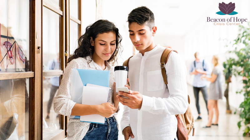 Couple of teens looking at a phone together